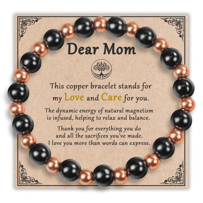 Magnetic copper bead bracelet displayed on Dear Mom gift card with mother's day blessing
