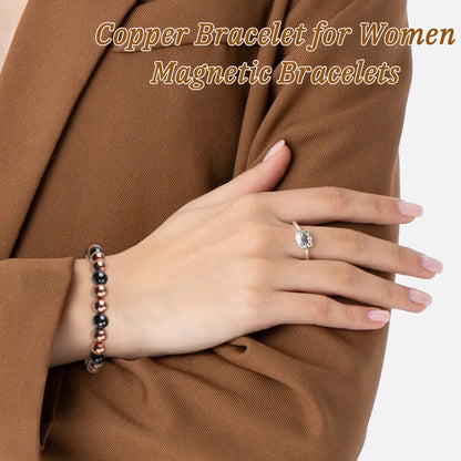 Woman wearing rose gold and black magnetic copper beaded bracelet with brown blazer