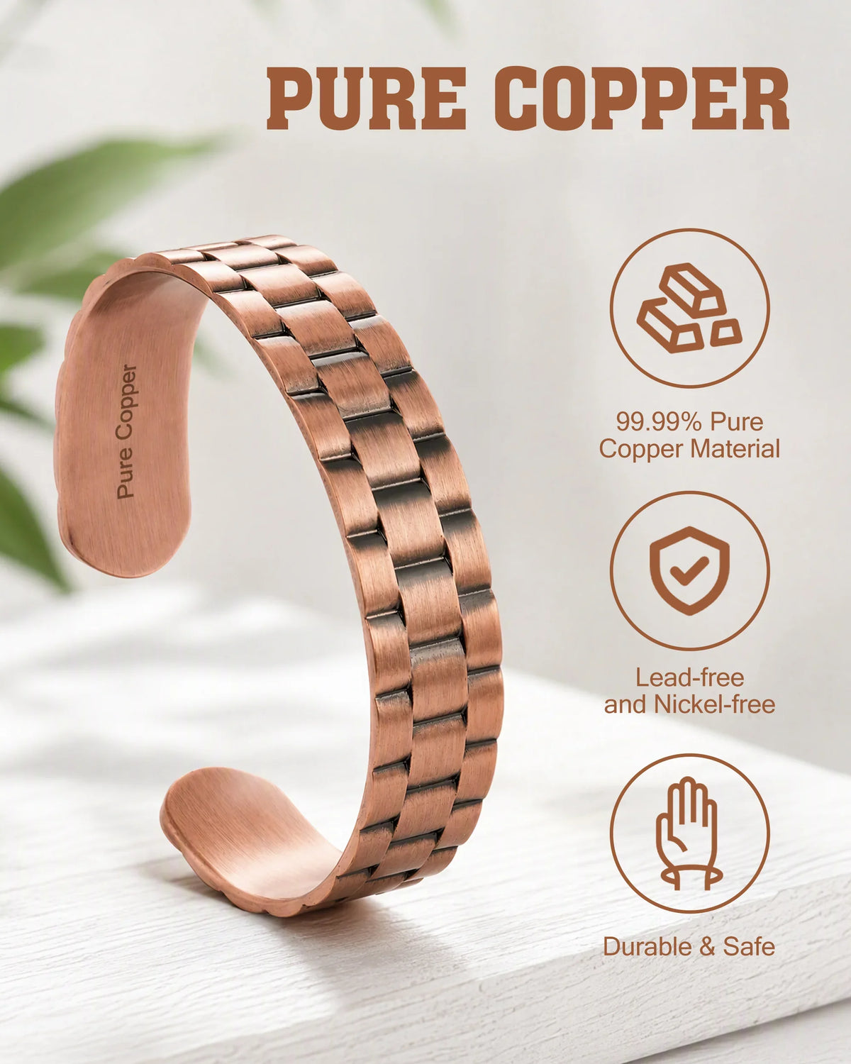 Close-up detail of brick-pattern textured segments and engraved Pure Copper stamp on solid copper cuff