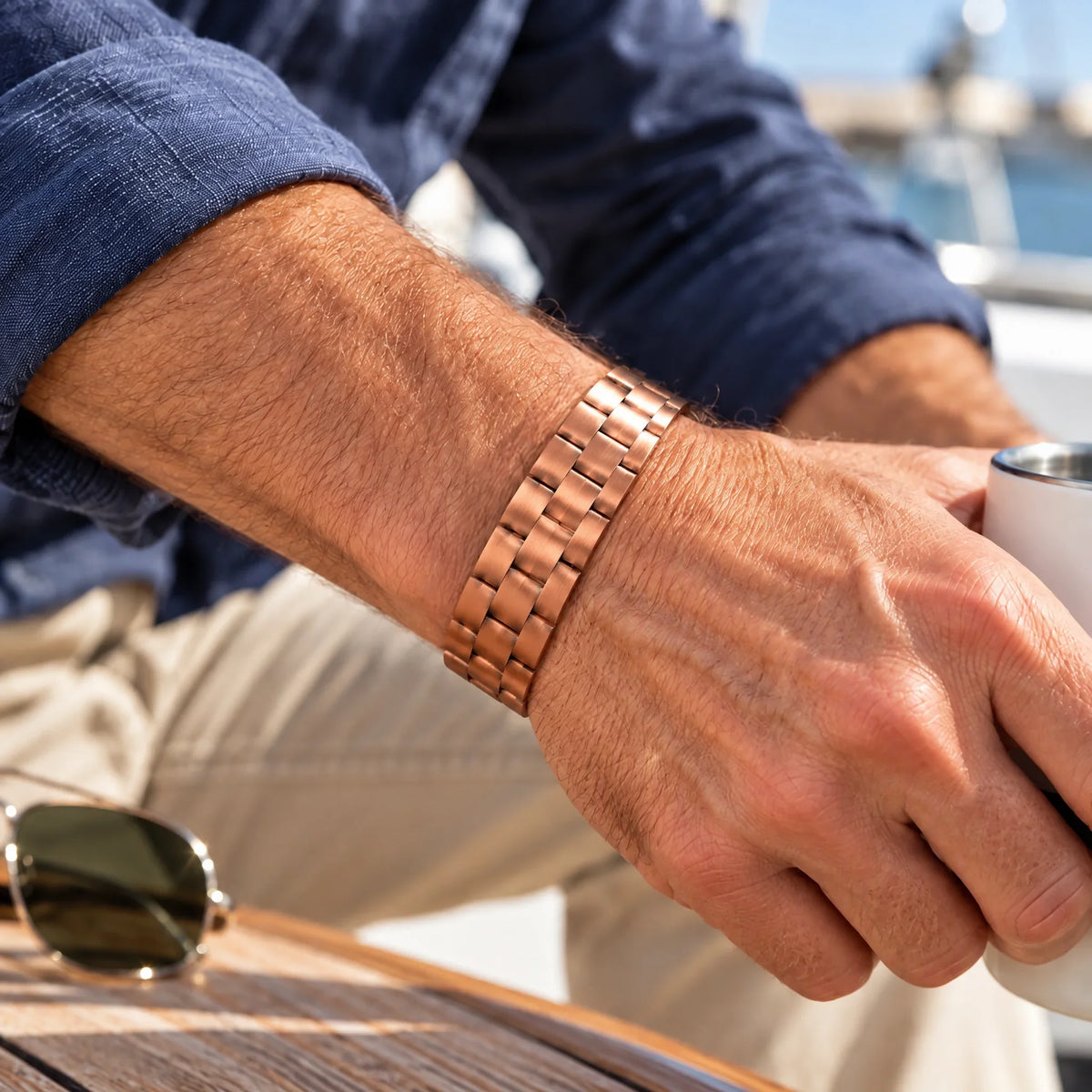 Men's brick-pattern copper cuff bracelet worn on male wrist showcasing daily styling and adjustable fit