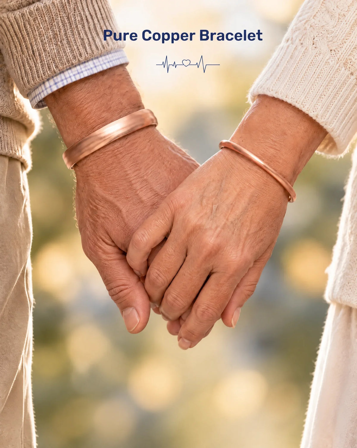 Close-up of couple holding hands wearing matching solid pure copper cuff bracelets outdoors
