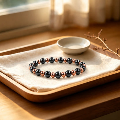 Magnetic copper beaded bracelet with 6mm pure copper and 8mm black magnetic beads on wooden tray