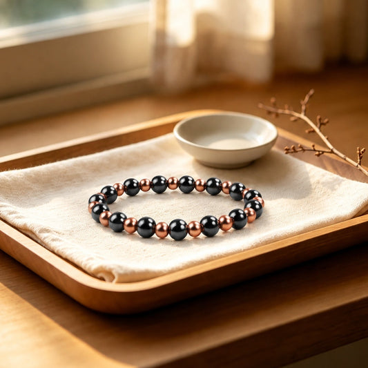 Magnetic copper beaded bracelet with 6mm pure copper and 8mm black magnetic beads on wooden tray